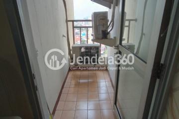 Balcony Cozy 2BR Apartment Middle Floor with Swimming Pool View at Mediterania Gajah Mada Apartment